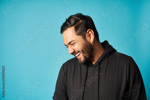 Smiling man near blue wall photo