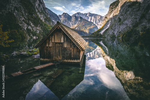 Fotografiet Landscape view of a wooden hut in the Obersee next to Koenigssee in Berchtesgade
