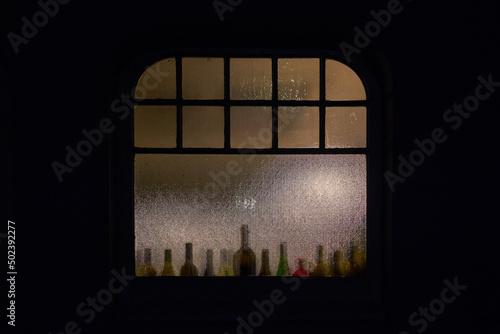 Closeup shot of drinks put near the window at night photo