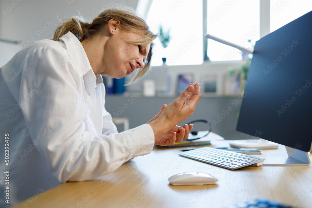 Office woman with carpal tunnel syndrome and wrist pain