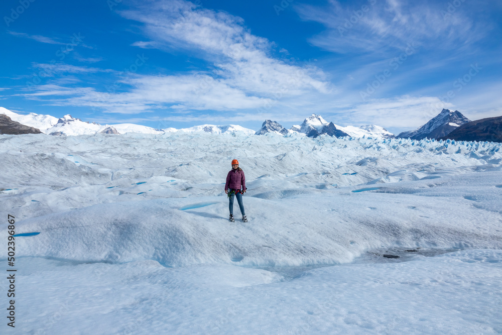 Female traveler posing at the Perito Moreno Glacier in El Calafate, Argentina, Patagonia, South America