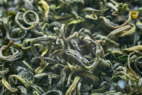 Chinese green tea dry leaves macro, view from above