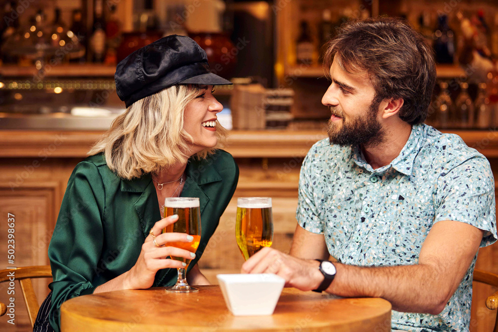 Caucasian couple having a drink at a bar. Caucasian couple having a drink at a bar.