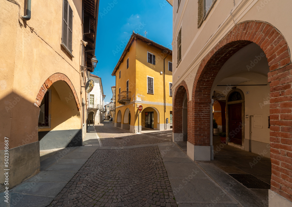 Bene Vagienna, Cuneo, Italy - May 02, 2022: Via Roma in the historic center of the town with ancient buildings with arcades