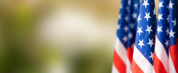 Group of American flags in green background.