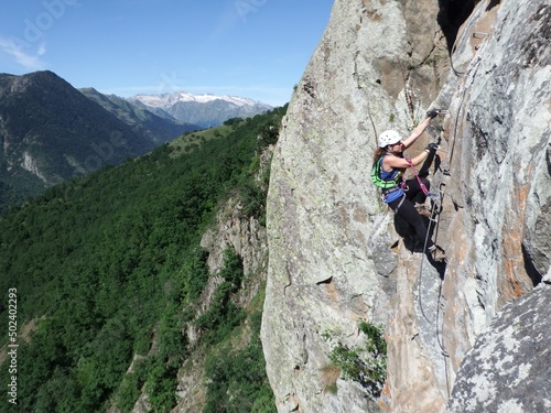 Woman rock climbing and via ferrata in the Pyrenees Spain
