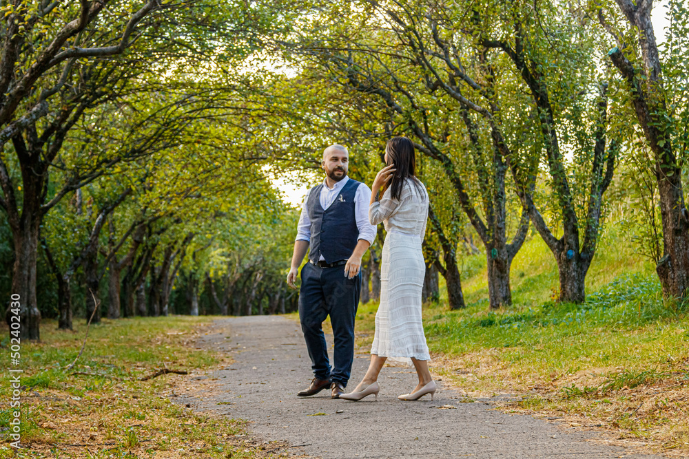 Fototapeta premium beautiful girl in a white dress and a guy in a fruit pair