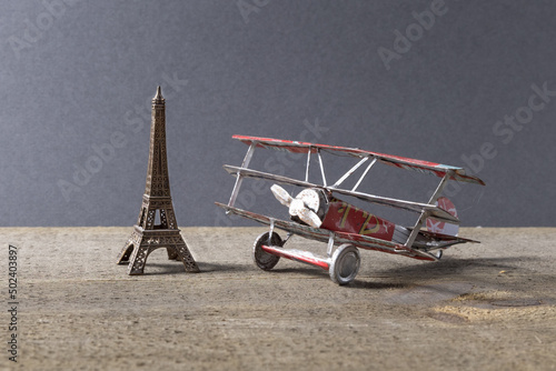 Old triplane and Eiffel tower figures on a table photo