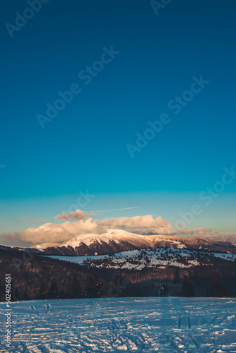 Beautiful scene of the snowy Kozi chrbat mountain in Low Tatras National Park in Slovakia at sunset photo