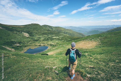 Active lifestyle. Traveling, hiking and trekking concept. Young man with backpack in the Carpathian mountains.