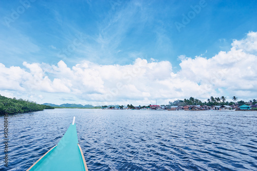 Travel by Philippines. Landscape with traditional fishing boat sailng the mangrove sea lagoon. © luengo_ua