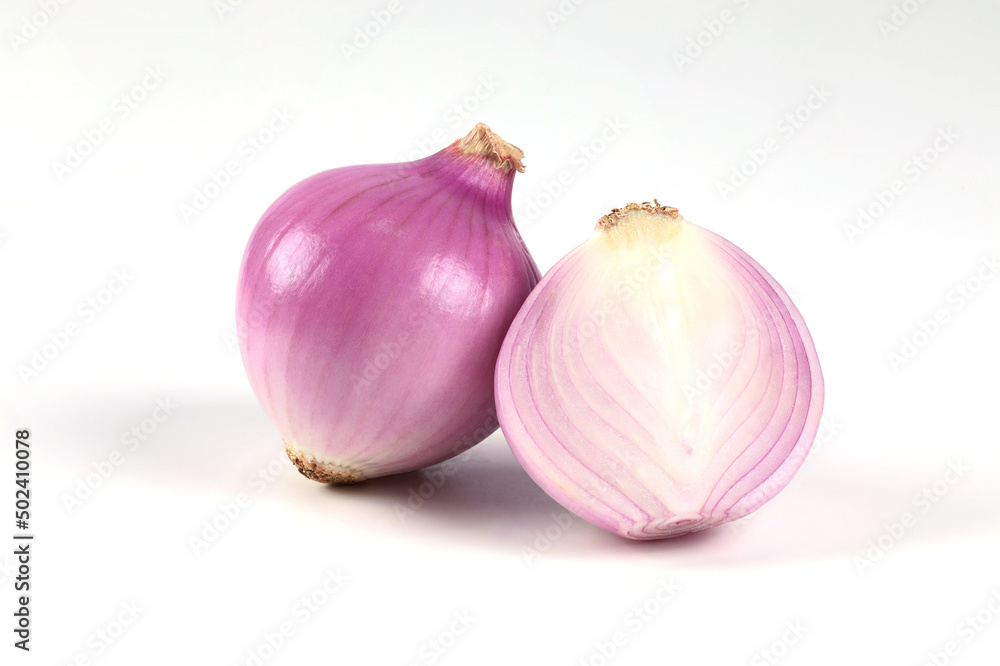 Fototapeta premium Red onion, peeled, halved, close-up placed on a white background