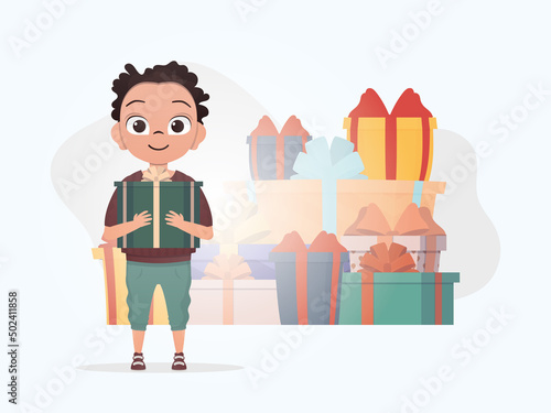 A little boy is holding a box with a bow in his hands. Christmas. Cartoon style.