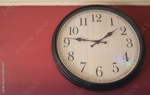  CLOCK ON A RED WALL