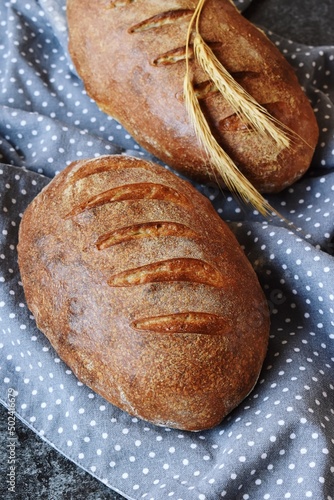 Homemade sourdough bread with seeds on the wooden background