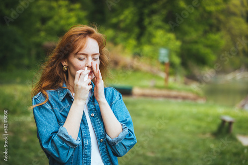 Woman is having flu and she is using nasal spray to help herself. Woman using nasal spray. Nasal spray to help a cold. Sick with a rhinitis woman dripping nose. Woman applies nasal spray