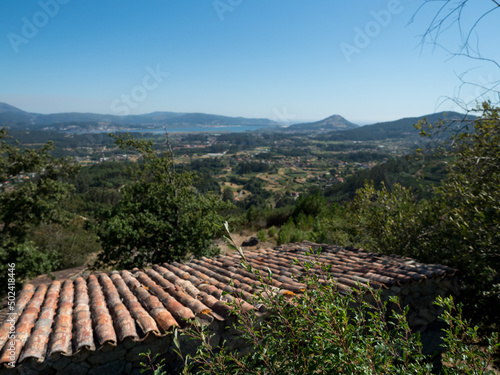 Antiqye rooftops with the view to the city in Route the Folon and Picon mills (Galicia) photo