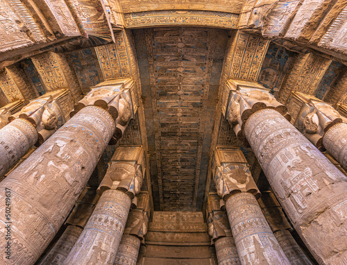 Dendera, Egypt -  November 17, 2021: Majestic columns inside the great ancient Egyptian temple of Dendera at Dendera, Egypt photo