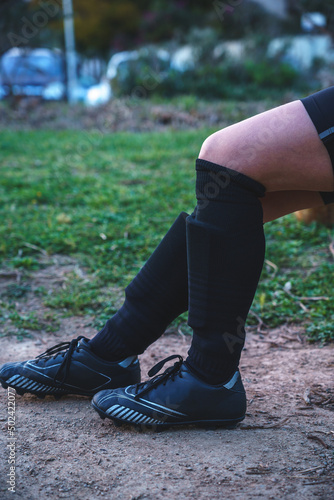 soccer girl tying shoelaces on sneakers photo