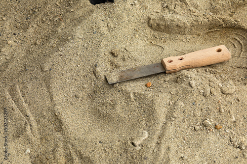 Skeleton and archaeological tools in the sand.Digging for fossils. photo