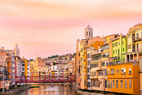 Beautiful view of the medieval city of Girona Spain with canal and historic colorful buildings seen at sunset. photo