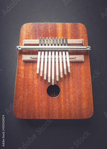 Traditional wooden kalimba isolated on black photo