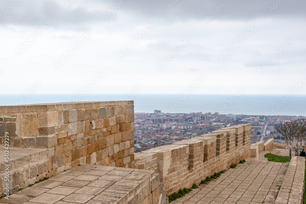 Derbent fortress Naryn Kala is the main touristic attraction in the city. Dagestan, North Caucasus, Russia. the city of Derbent in the distance, the blue sea and the sky.