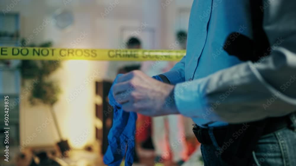 Detective wearing gloves to explore crime scene in trashed apartment, homicide Detective wearing gloves to explore crime scene in trashed apartment, homicide
