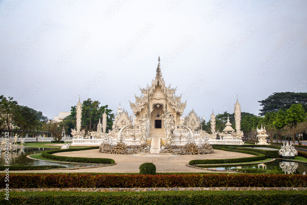 Fototapeta premium Aerial view of Wat Rong Khun, the white temple, at sunrise, in Chiang Rai, Thailand