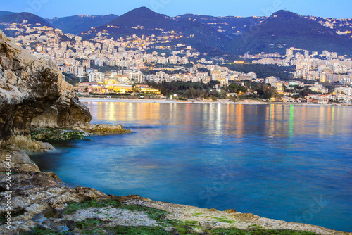 Scenic view of a coast of Jounieh with rocks and builings on the mountain slope photo