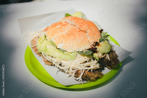 Traditional cemita from Puebla, a dish made up of bread with sesame seeds, cheese, avocado, onion and chicken or pork milanese. photo