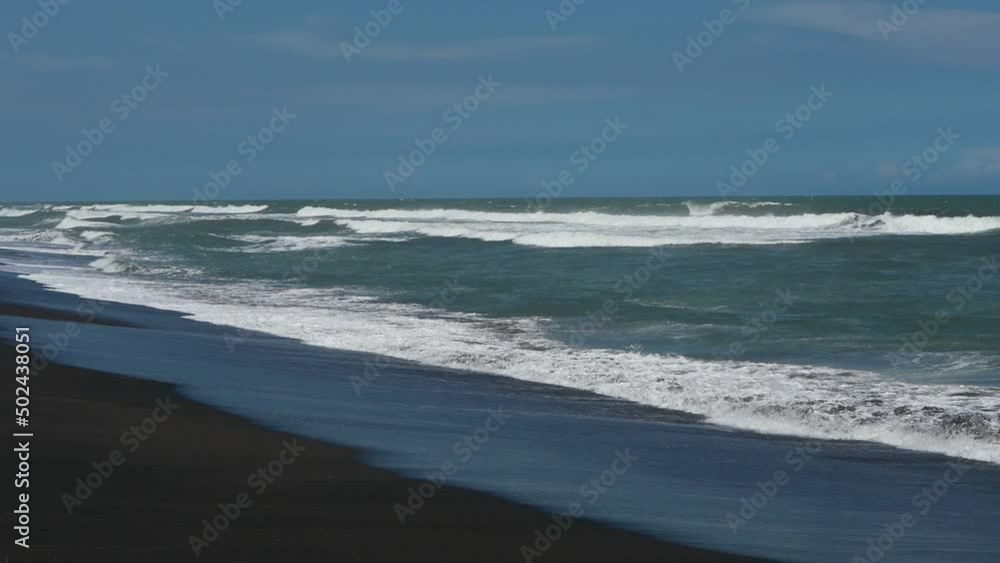 Yogyakarta, Indonesia - On a beautiful tropical beach with quite big waves it is perfect for tourist attractions Yogyakarta, Indonesia - On a beautiful tropical beach with quite big waves it is perfect for tourist attractions