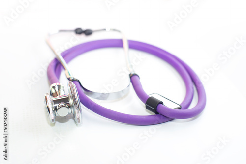 medical stethoscope purple color, on a white background