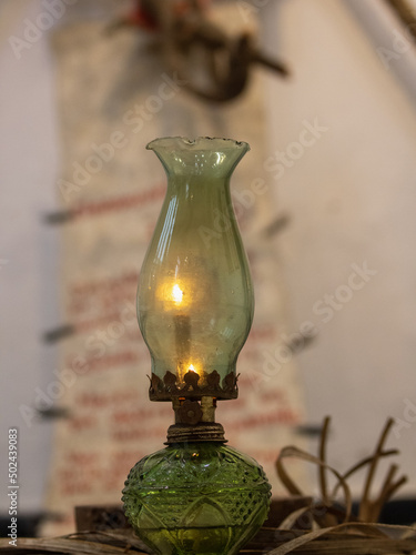 Vertical of the burning kerosene lamp in the house photo