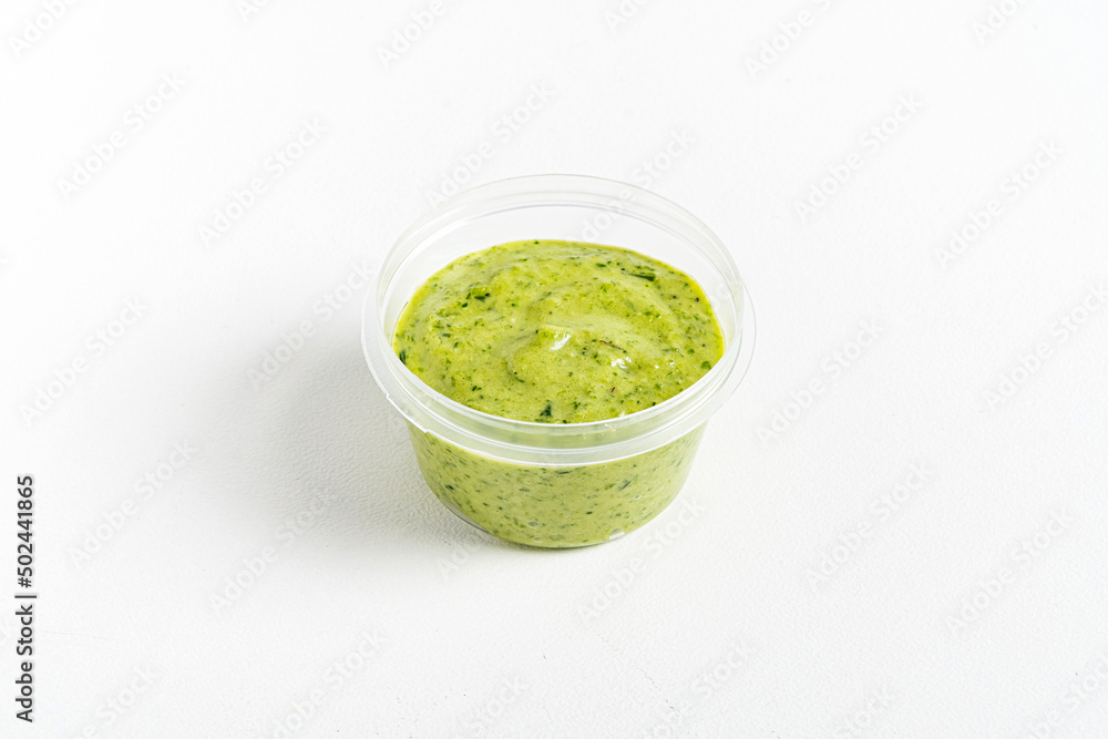 green sauce dip on white