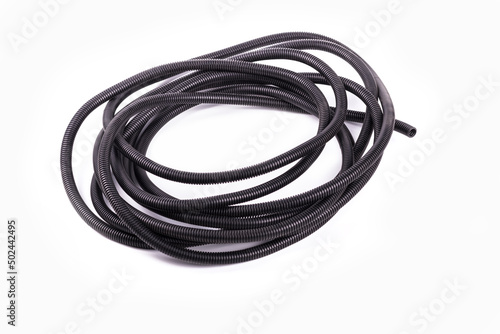 on a white background. black corrugated tube for laying cable in the car