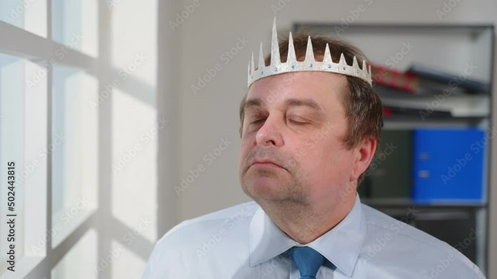 Portrait of smug man puts crown on his head with pride, megalomania. Portrait of smug man puts crown on his head with pride, megalomania.