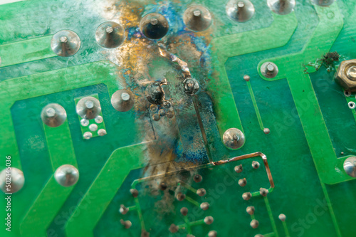 Short circuit on the printed circuit board. Failed electronics. Malfunction of the electronic component on the PCB. Electronics repair. Selective focus