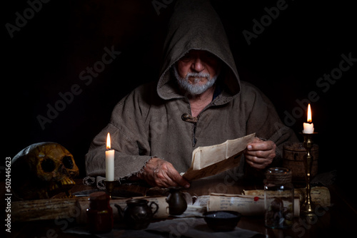 Old medieval man studies occultism