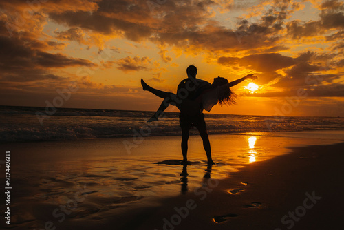 silhouette of person on the beach at sunset