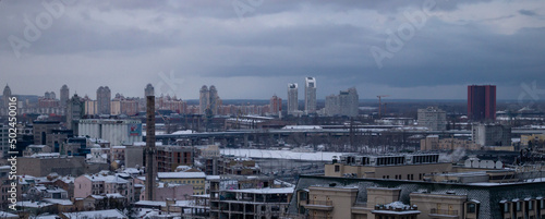 View on the city in cloudy day at winter. A lot of building in cloudy winter day. View on the city at winter. Aerial shot of the beautiful Kyiv
