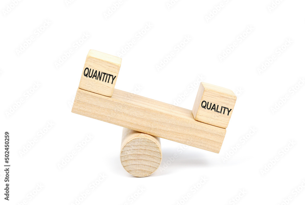Wooden blocks designed as a seesaw with Quality outweighs the Quantity, Business Quality Vs Quantity Concept. Wooden blocks designed as a seesaw with Quality outweighs the Quantity, Business Quality Vs Quantity Concept.