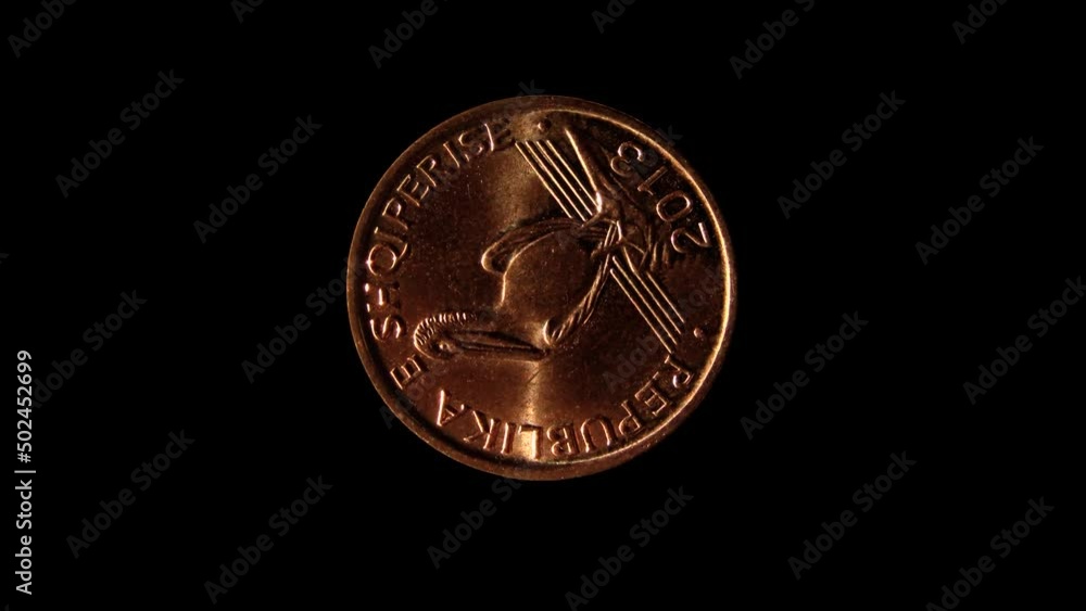 Obverse of Albania coin 1 lek 2013 with inscription meaning REPUBLIC OF ALBANIA. Isolated in black background. Obverse of Albania coin 1 lek 2013 with inscription meaning REPUBLIC OF ALBANIA. Isolated in black background.
