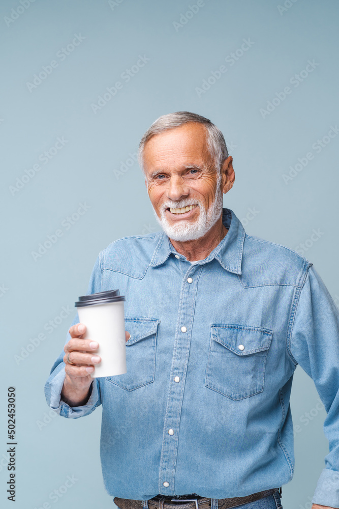No life without coffee. Handsome mature man holding white mocup paper cup with morning coffee and showing love to this beverage. Indoor, isolated, studio shot No life without coffee. Handsome mature man holding white mocup paper cup with morning coffee and showing love to this beverage. Indoor, isolated, studio shot