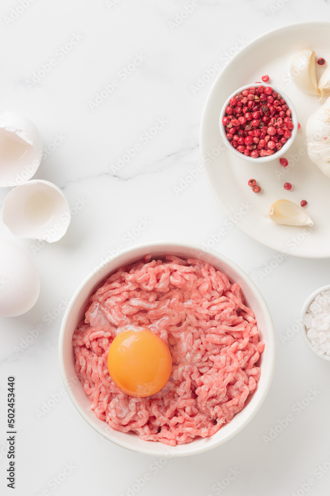 Cutlet ingredients beef farce meat with egg in a plate Cutlet ingredients beef farce meat with egg in a plate