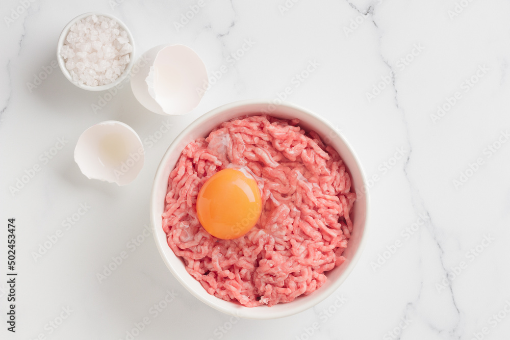 Cutlet ingredients beef farce meat with egg in a plate Cutlet ingredients beef farce meat with egg in a plate