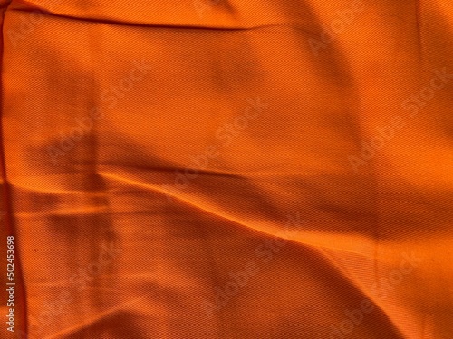 Orange cloth background. Old dark orange color fabric. Fashion design clothes texture