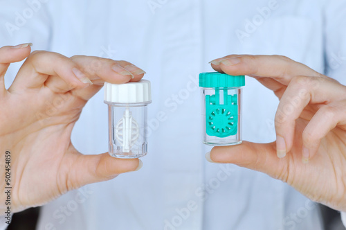 Contact Lens Care. Women's hands hold two different types of soft contact lens boxes.Eye Care And Vision Concept.