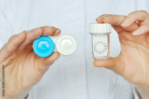 Contact Lens Care. Women's hands hold two different types of soft contact lens boxes.Eye Care And Vision Concept. photo