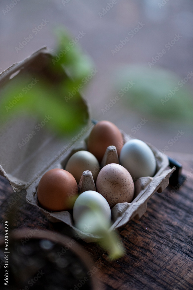 Chicken eggs in a basket on a wooden table Chicken eggs in a basket on a wooden table